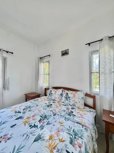 Cozy bedroom with floral bedding and natural light from windows