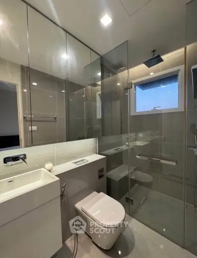 Modern bathroom with glass shower and sleek fixtures