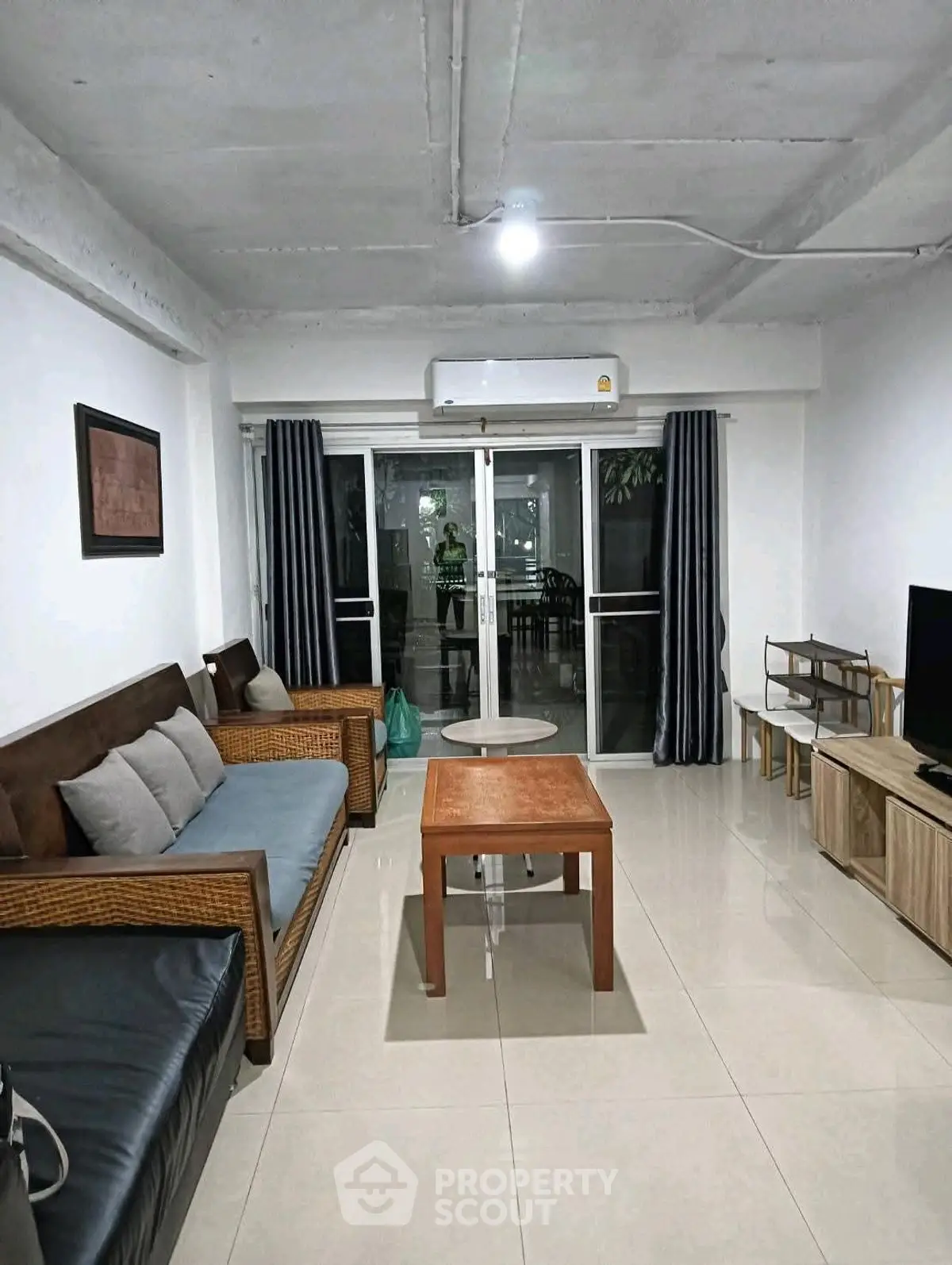 Spacious living room with modern furniture and large windows for natural light.