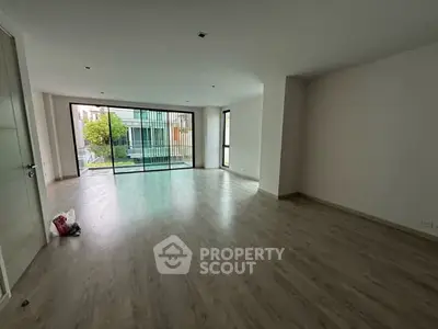 Spacious empty living room with large windows and modern flooring