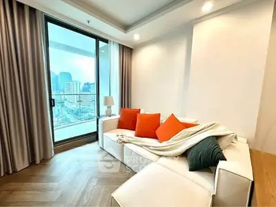 Modern living room with city view and cozy white sofa with colorful cushions.