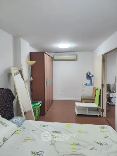 Spacious bedroom with modern decor and ample storage in a cozy apartment.