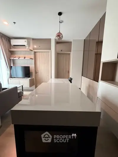 Modern open-plan living room with sleek kitchen island and stylish decor