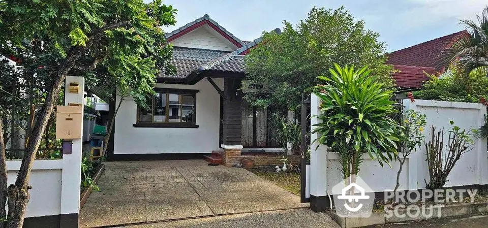 Charming single-story house with lush garden and spacious driveway in a serene neighborhood.