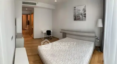 Spacious modern bedroom with wooden flooring and minimalist decor