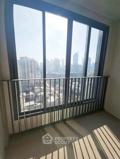 Stunning city view from high-rise balcony with sleek railing design.