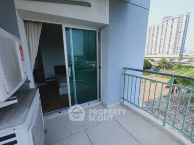 Spacious balcony with city view and sliding glass doors