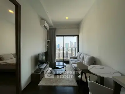 Modern living room with city view, featuring sleek furniture and natural light.
