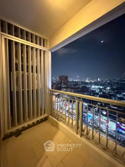 Stunning city view from a high-rise balcony at night, perfect for urban living.