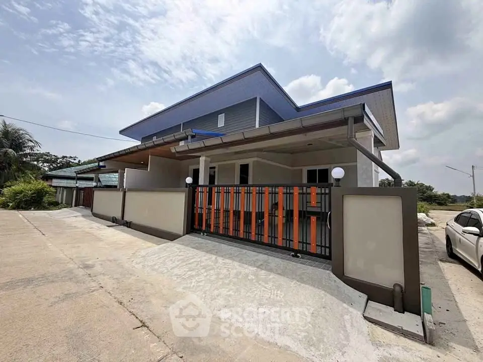 Modern single-story house with sleek design and spacious driveway