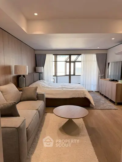 Modern bedroom with cozy seating area and large windows