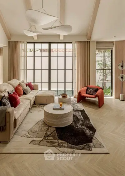 Luxurious living room with modern decor, large windows, and stylish furniture.