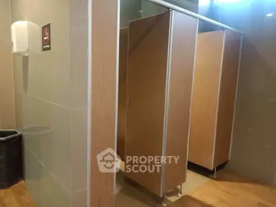 Modern public restroom with wooden stalls and sleek design