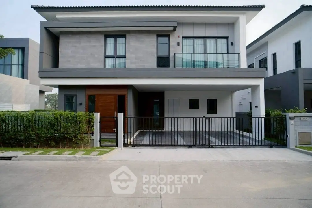 Modern two-story house with sleek design and spacious driveway in a serene neighborhood.