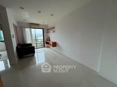 Spacious minimalist living room with large window and balcony access, offering a serene view.