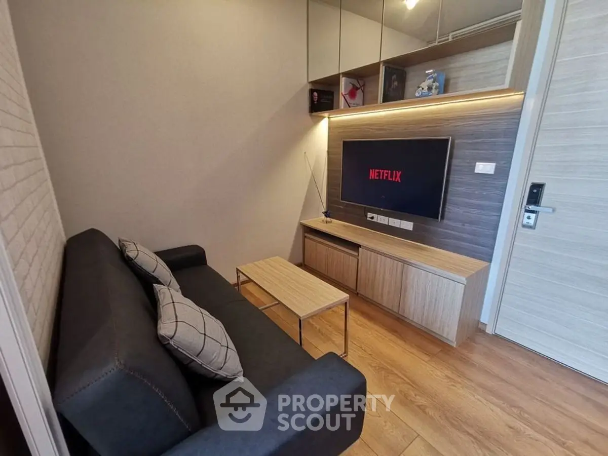Modern living room with sleek furniture and wall-mounted TV