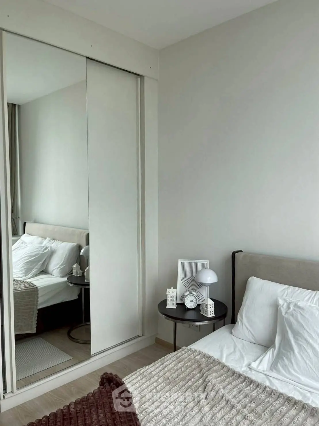 Modern bedroom with mirrored closet and cozy decor