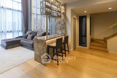 Luxurious modern living room with elegant marble bar and cozy seating area.