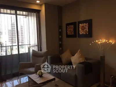 Modern living room with stylish decor and city view from window.