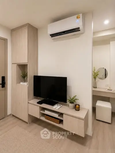 Modern living room with sleek TV unit and air conditioning in stylish apartment.