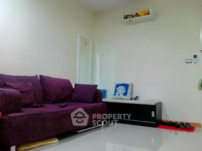 Cozy living room with purple sofa and modern decor