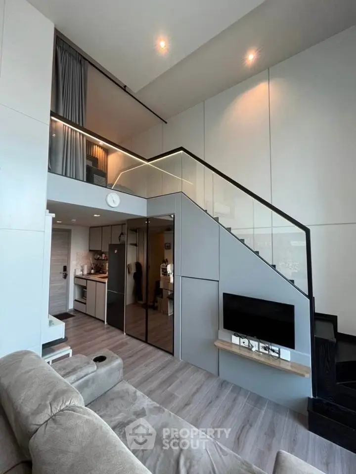 Modern loft apartment with mezzanine, sleek design, and open layout in urban setting.