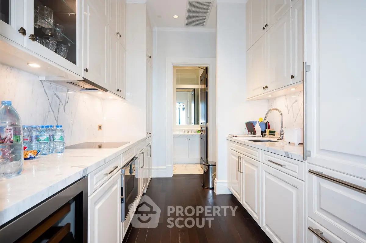 Luxurious kitchen with sleek cabinetry and modern appliances in a high-end home.