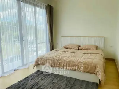 Bright bedroom with large windows and cozy bedding in modern apartment