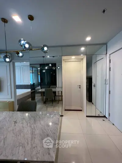 Modern interior with marble dining table and stylish lighting in a contemporary apartment.