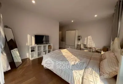 Spacious bedroom with modern decor and ample natural light