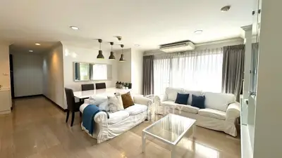 Spacious living room with elegant decor and natural light in modern apartment.