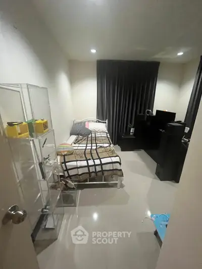 Cozy bedroom with modern decor and sleek furnishings, perfect for a comfortable living experience.