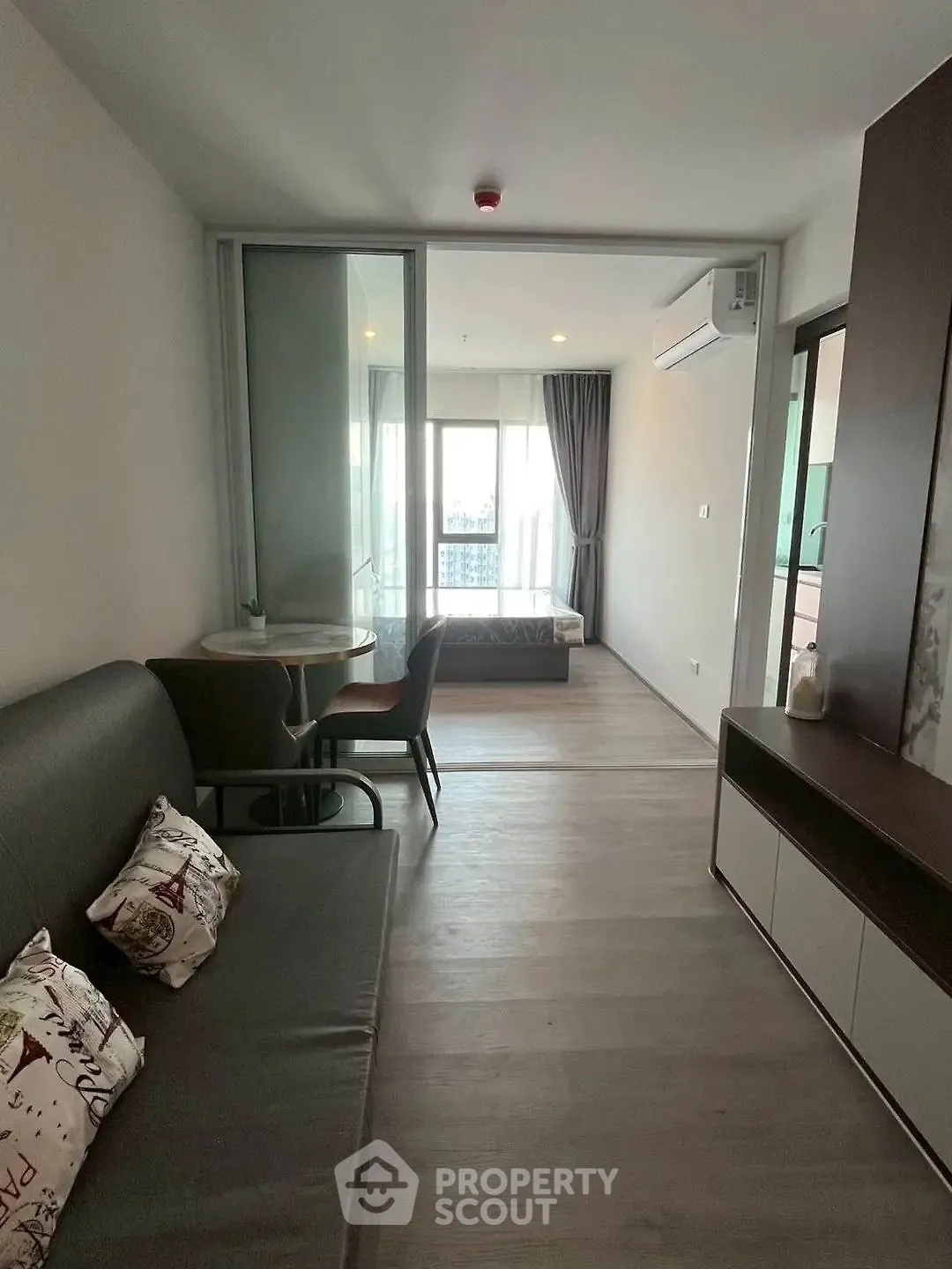 Modern apartment interior with cozy living area and bedroom view.