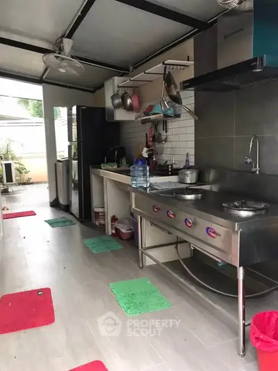 Spacious kitchen with stainless steel appliances and open layout, perfect for culinary enthusiasts.