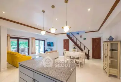 Spacious open-plan living room with modern kitchen and stylish decor