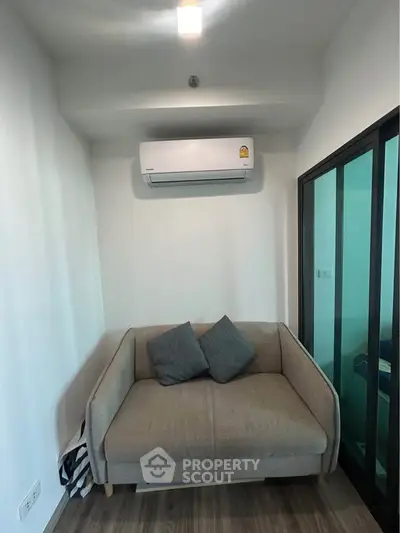 Cozy living room with modern air conditioning and stylish sofa, perfect for relaxation.