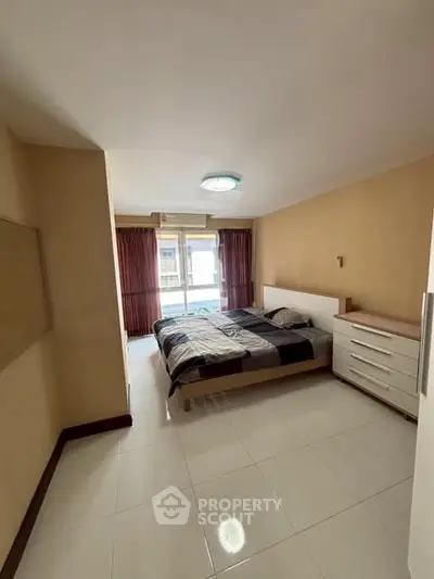 Spacious bedroom with modern furnishings and natural light