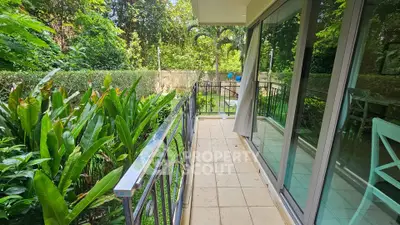 Charming garden view from a cozy balcony with lush greenery