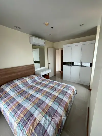 Modern bedroom with stylish decor and ample storage space