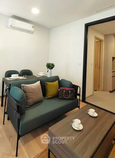Modern living room with stylish furniture and dining area in a cozy apartment.