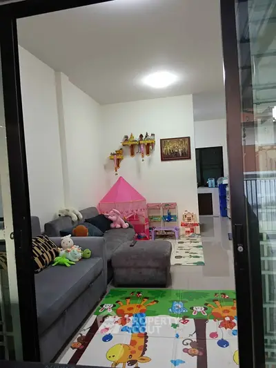 Charming family-friendly living room with playful decor and cozy seating area.