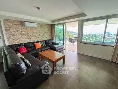 Spacious living room with modern decor and stunning balcony view