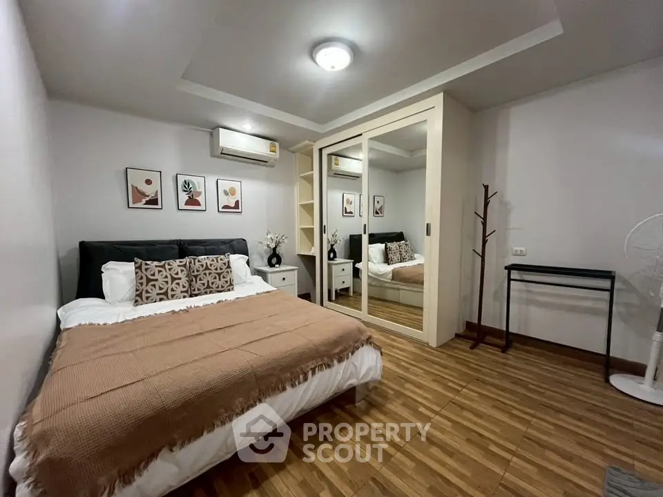 Cozy bedroom with modern decor and mirrored wardrobe