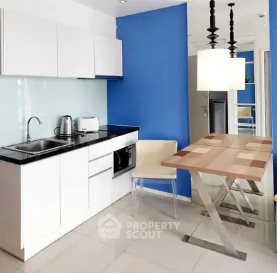 Modern kitchen with sleek white cabinets and stylish dining area