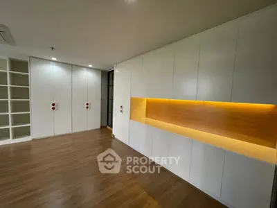 Spacious modern living room with built-in storage and warm lighting