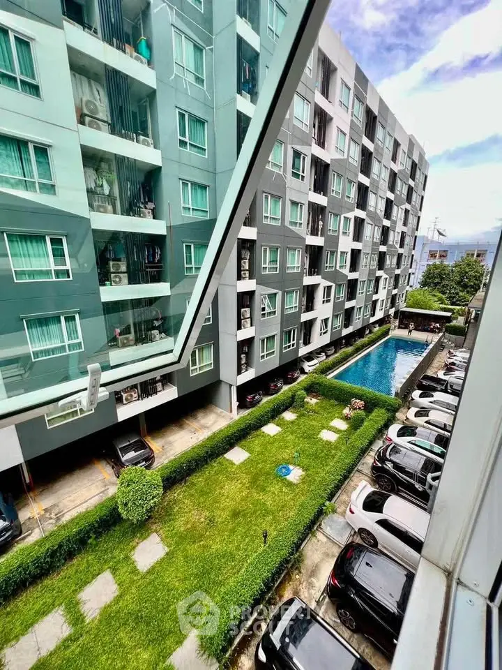 Modern apartment building with pool and parking view from window