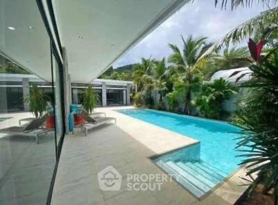 Luxurious modern villa with stunning pool and lush tropical garden