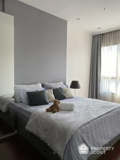 Cozy bedroom with plush bedding and natural light