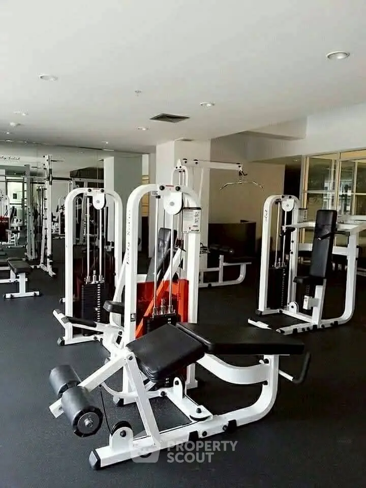 Spacious modern gym with state-of-the-art fitness equipment in a luxury residential building.