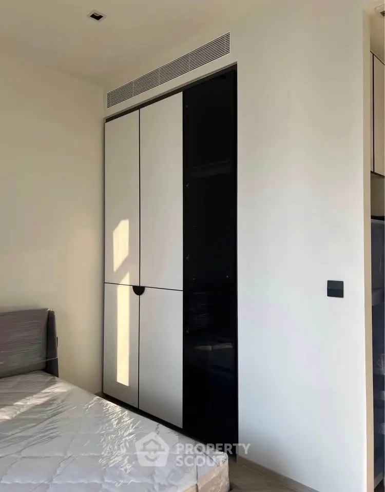 Modern bedroom with sleek built-in wardrobe and natural light